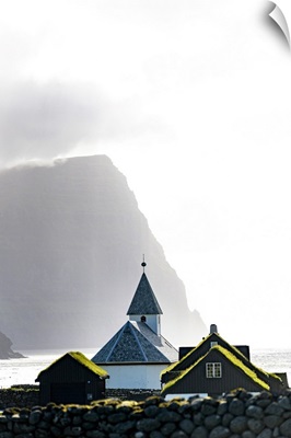 Misty Sky Over The Church Of Vidareidi Ovelooking A Fjord, Vidoy Island, Faroe Islands