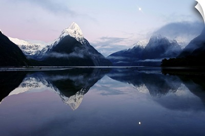 New Zealand, Fiordland, Milford Sound and moon during a cold and misty sunrise