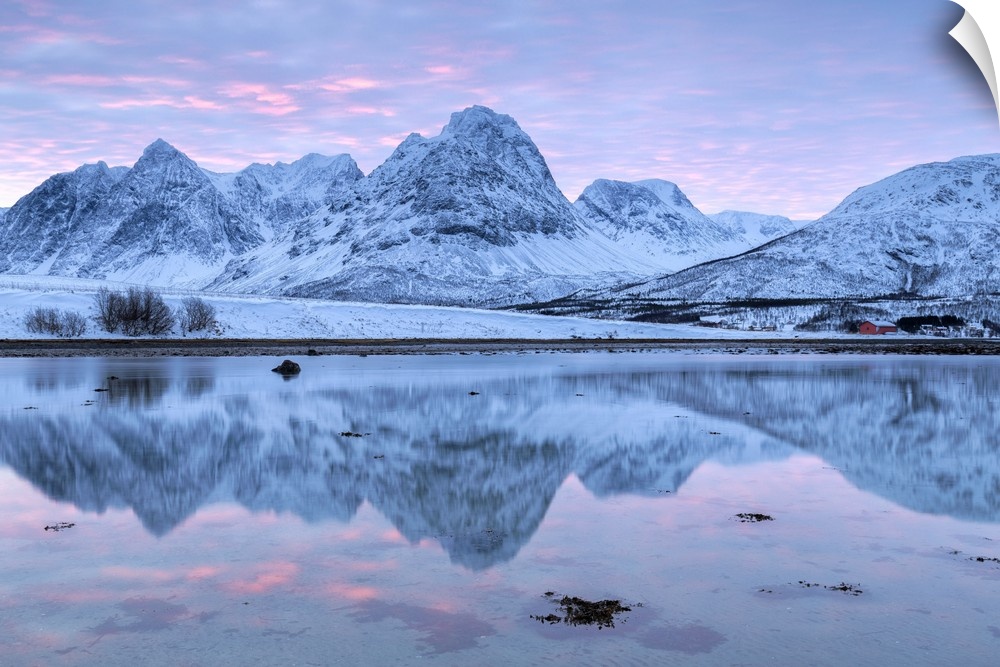 Rakeltinden is reflected in the fjord. Storsteinnes, Balsfjorden, Lyngen Alps, Troms, Norway, Lapland, Europe.