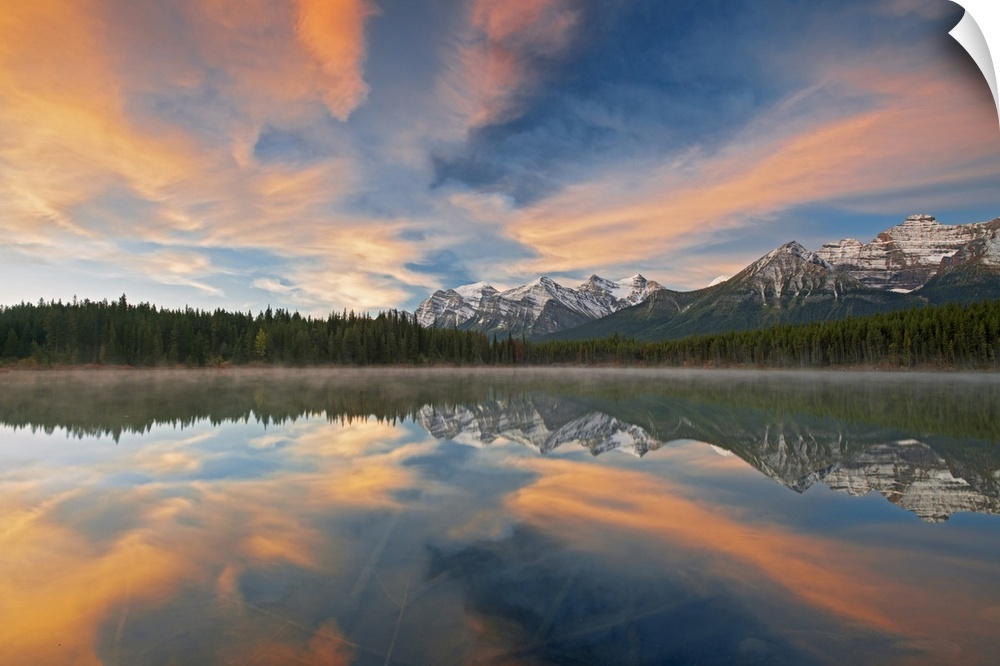 Clouds and Rocky Mountains reflected in Herbert Lake, Banff National Park, Alberta, Canada