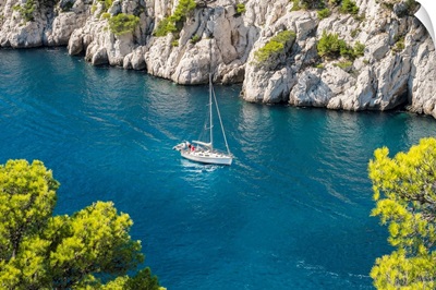 Sailboat Passing Through Emerald Blue Water Of Calanque De Port-Pin, France