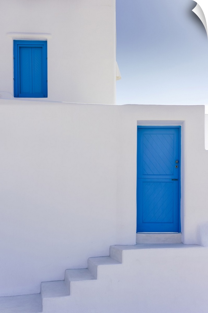 Santorini, Cyclades Islands, Greece. Minimal architecture, white walls and stair, blue door and window.
