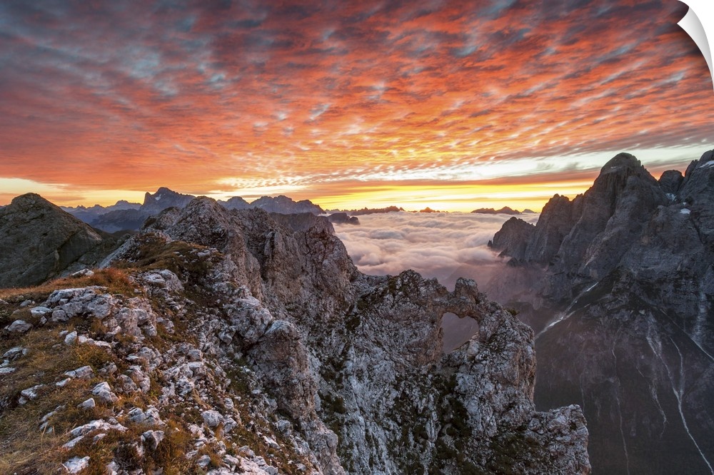 Colorful sunrise over the ridges of the Pale of the Balconies, Pala group, Dolomites, Italy. In the background mount Civet...