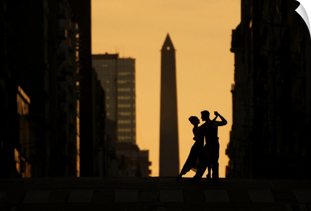 A couple of Professional Tango dancers on Avenida Corrientes at sunset, with the Obelisk monument in the background. Bueno...