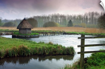 Thatched fisherman's hut and eel traps spanning the River Test near Hampshire, England.