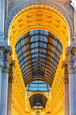 The entrance to the Galleria Vittorio Emanuele II illuminated at dusk