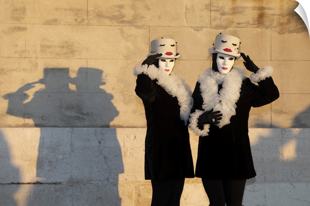 Two women pose in identical costumes during the Venice Carnival, San Giorgio Maggiore, Venice, Veneto, Italy