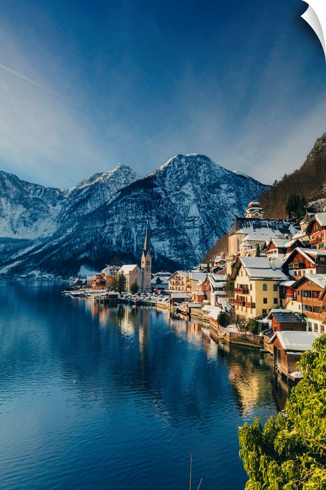 Typical village called Hallstatt con the Hallstatter see at sunrise with the houses reflecting in the lake.