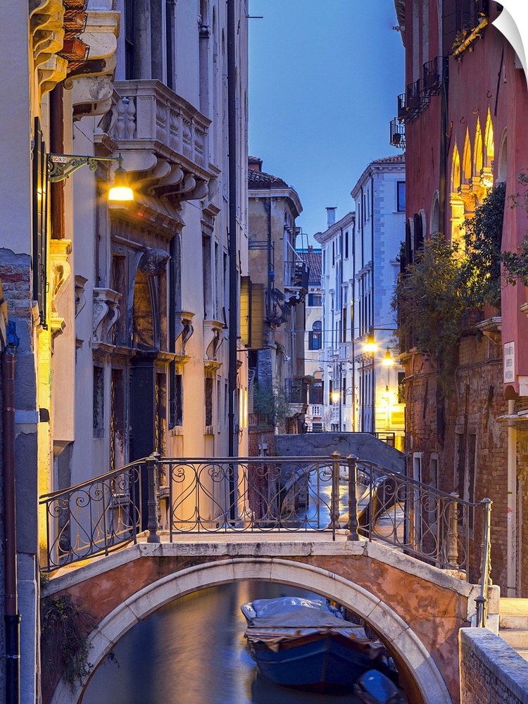 Venice, Veneto, Italy. View over a bridge and a canal at dusk.