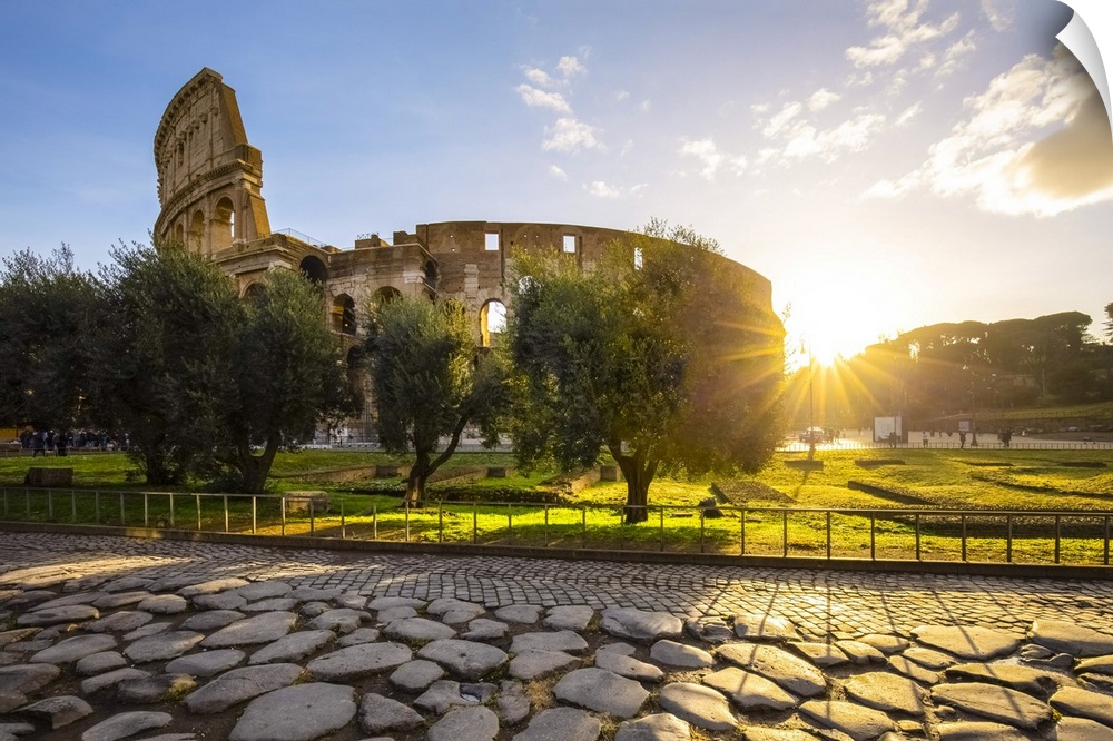 View of the Colosseum during a winter sunrise from the Via Sacra. Rome, Lazio, Italy.