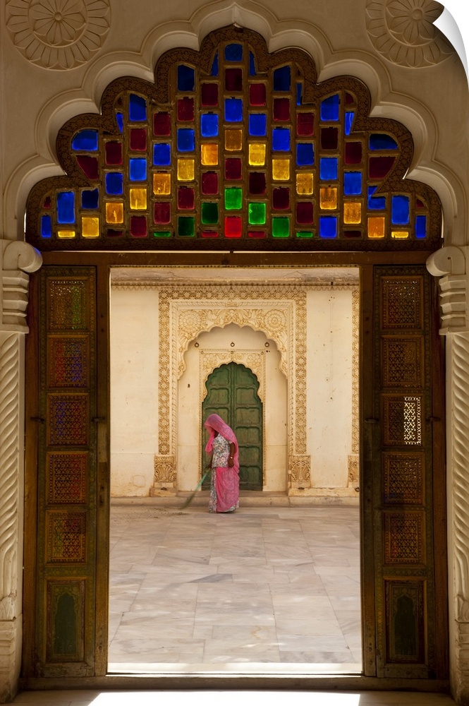 View through doorway of woman sweeping, Meherangarh Fort, Jodhpur, Rajasthan, India