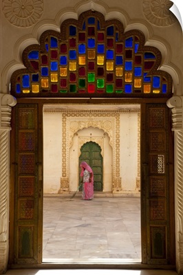 View through doorway of woman sweeping, Meherangarh Fort, Jodhpur, India