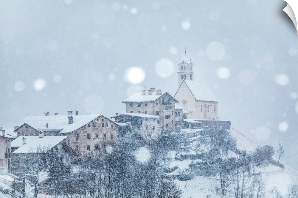 The Ancient Village Of Colle Santa Lucia With The Church On The Hill Under A Snowfall, Agordino, Belluno, Veneto, Italy.