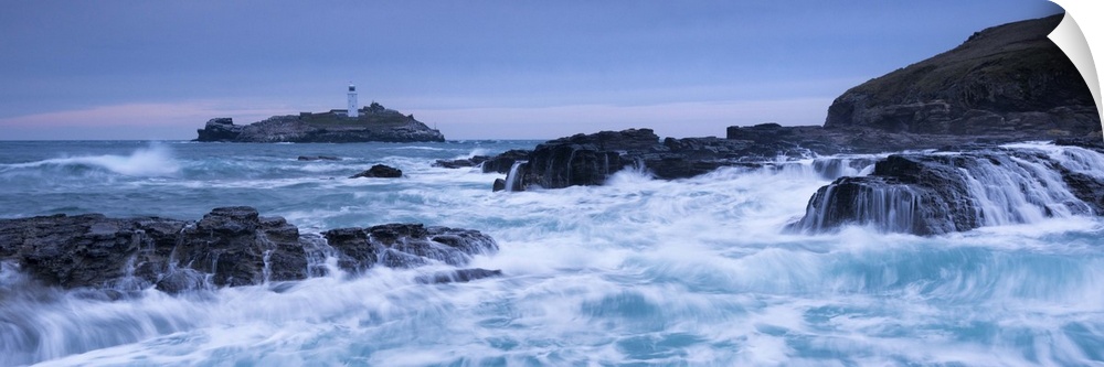 Waves crash around the rocks near Godrevy Lighthouse, Cornwall, England. Winter (February)
