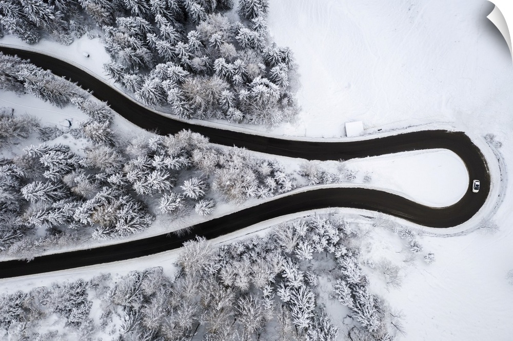 Aerial view of the winding road of the Presolana Pass after a winter snowfall. Presolana pass, Colere, Seriana Valley, Ber...