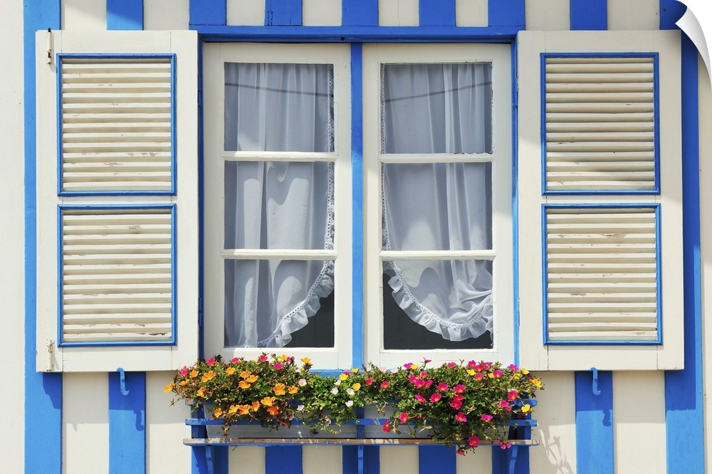 Window of a traditional striped painted house in the little seaside village of Costa Nova, Portugal