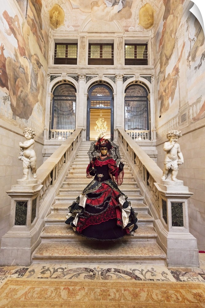 Woman in costume standing on staircase in Ca Segredo palace during Carnival, Venice, Veneto, Italy