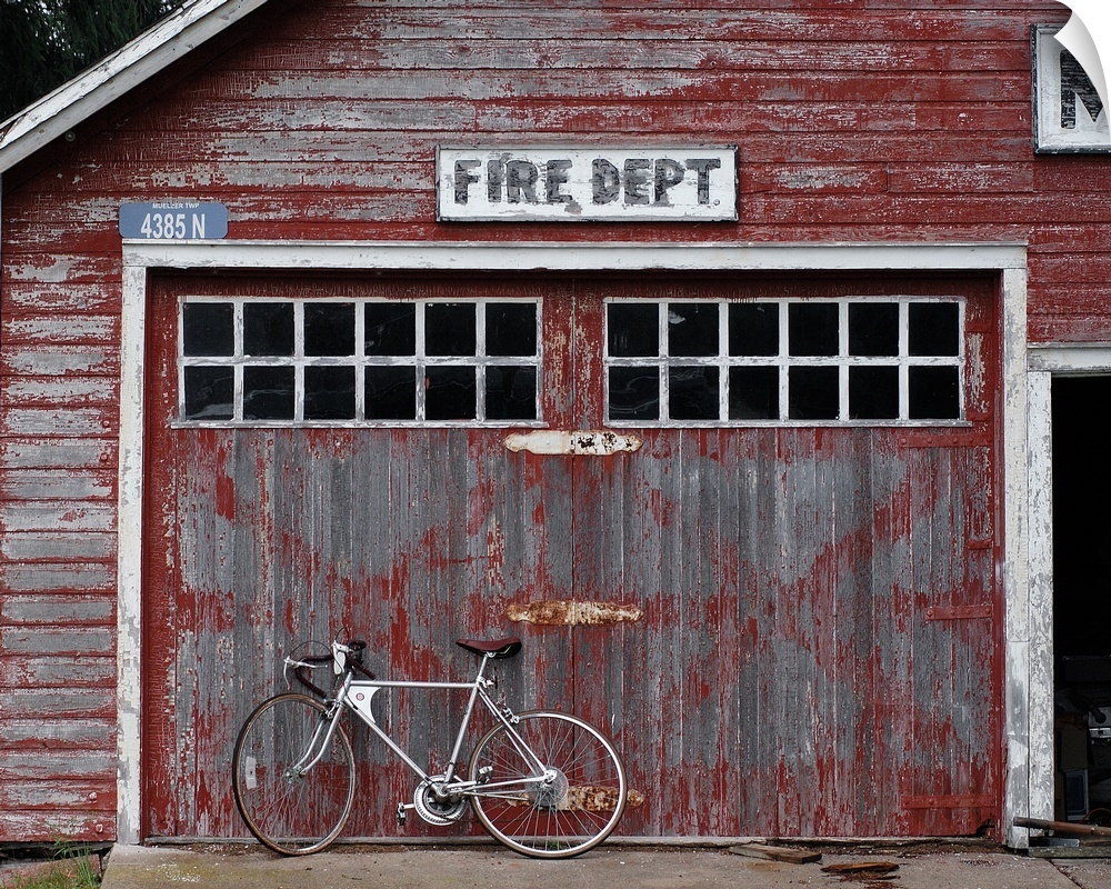 Rustic fire dept. with a bicycle leaning against it in Michigan