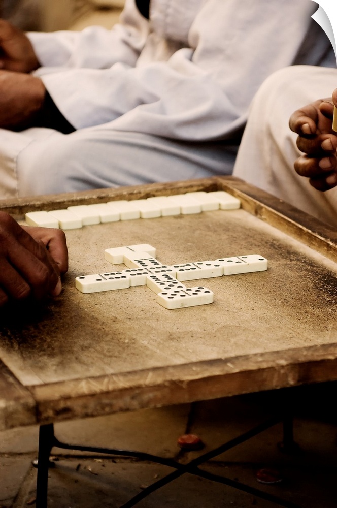 A group of older men converse and play the ancient form of Dominoes in Luxor, Egypt. Dominoes is an ancient Egyptian.game ...