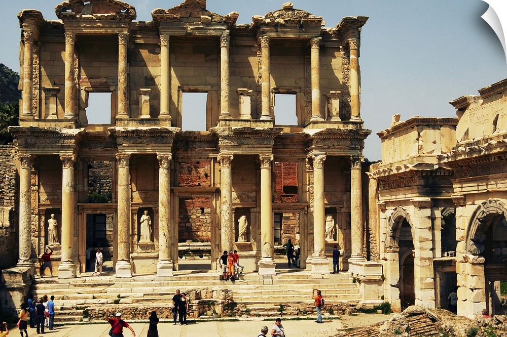 Tourists gather around the archaeological remains of the Library of Celsus; Ephesus, Turkey. Ephesus, located along the we...