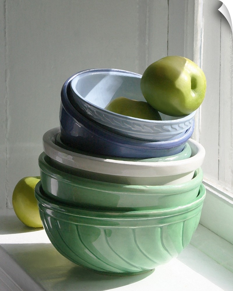 A stack of ceramic bowls with green apples on a windowsill.