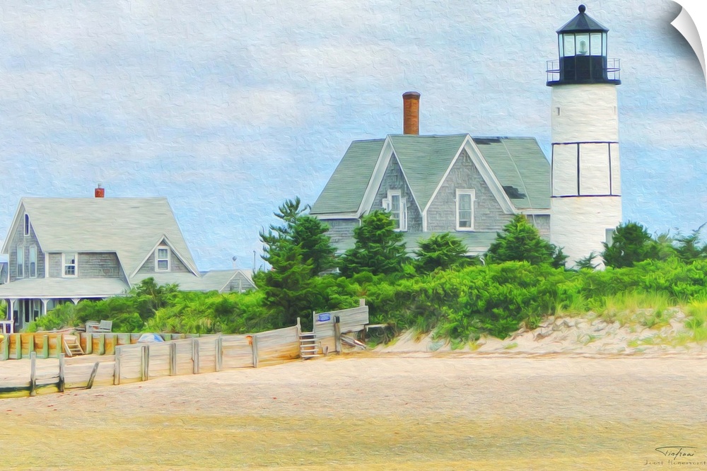 A lighthouse on the edge of a sandy beach in New England.