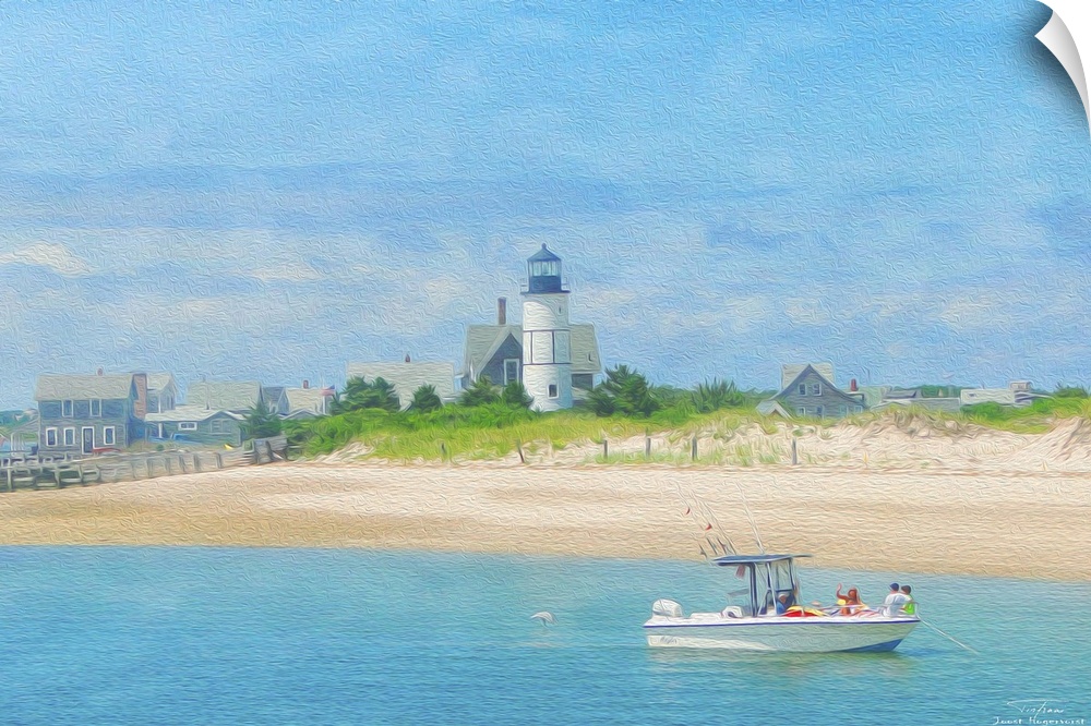 A lighthouse on the beach with a boat on the water in New England.