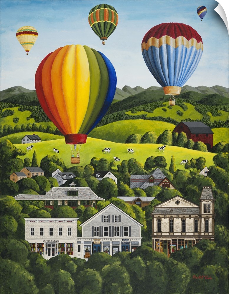Colorful hot air balloons floating above a hillside town.