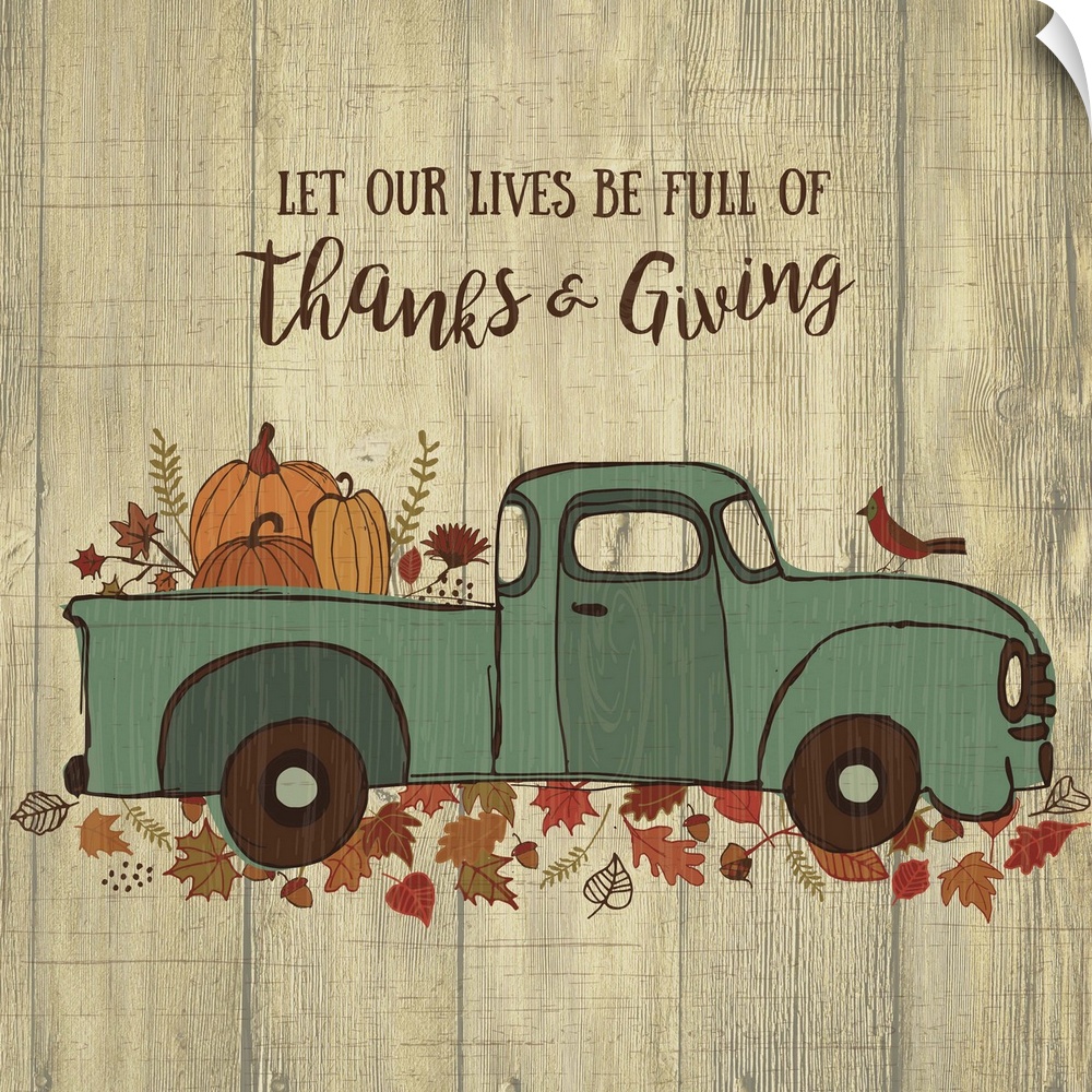 Thanksgiving themed decor of a blue truck carrying pumpkins on a leafy trail.