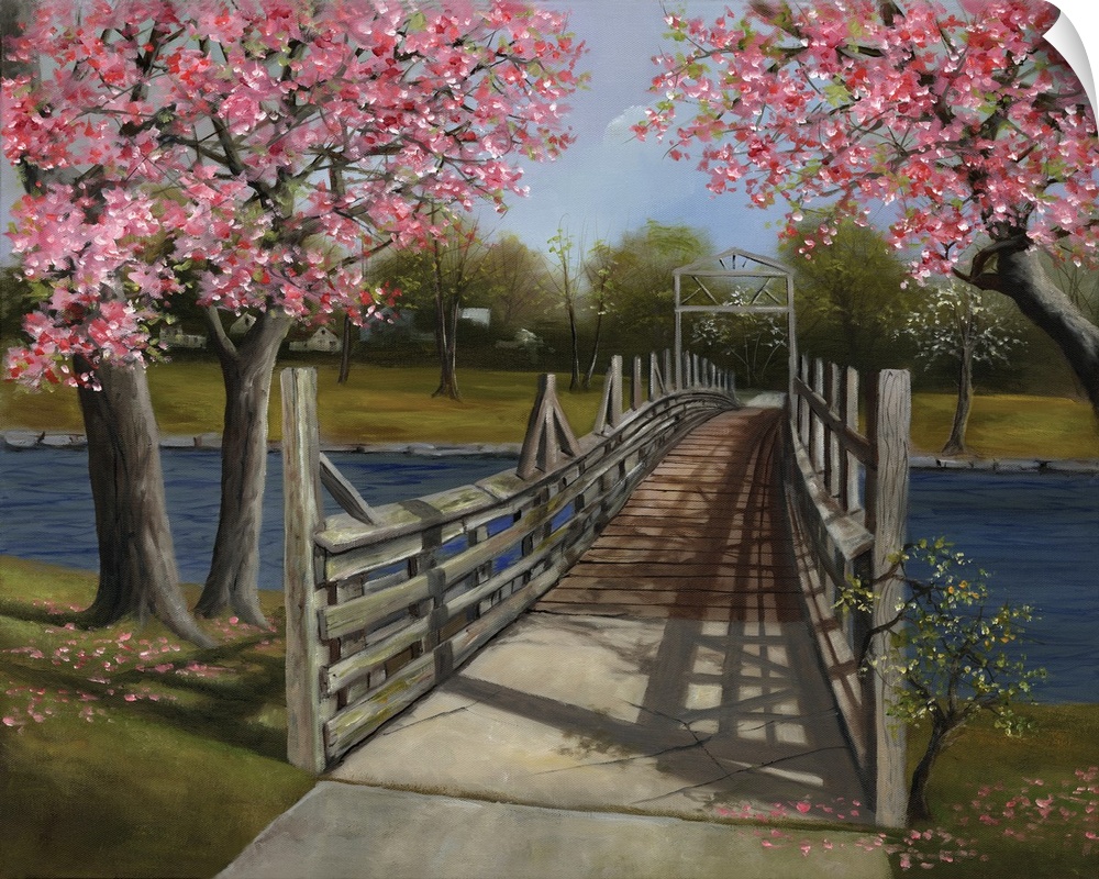 A wooden bridge across a river under blossoming trees.