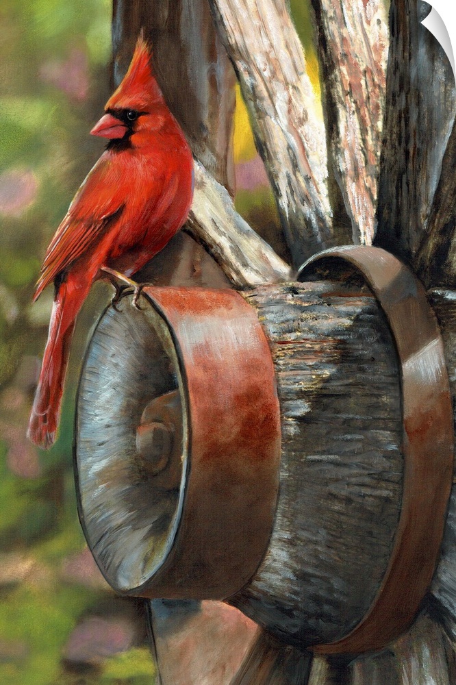 A bright red cardinal sitting on the edge of a wagon wheel.