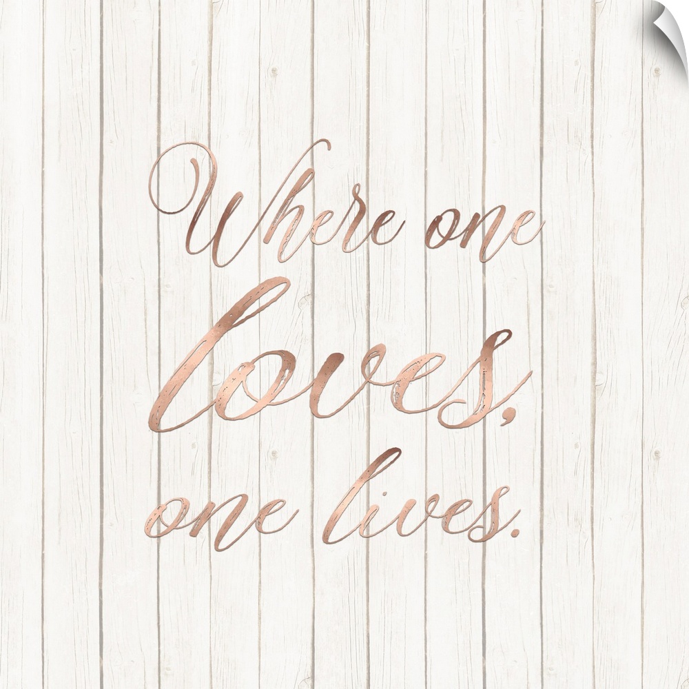 "Where One Loves, One Lives." written in rose gold on a wood paneled background.