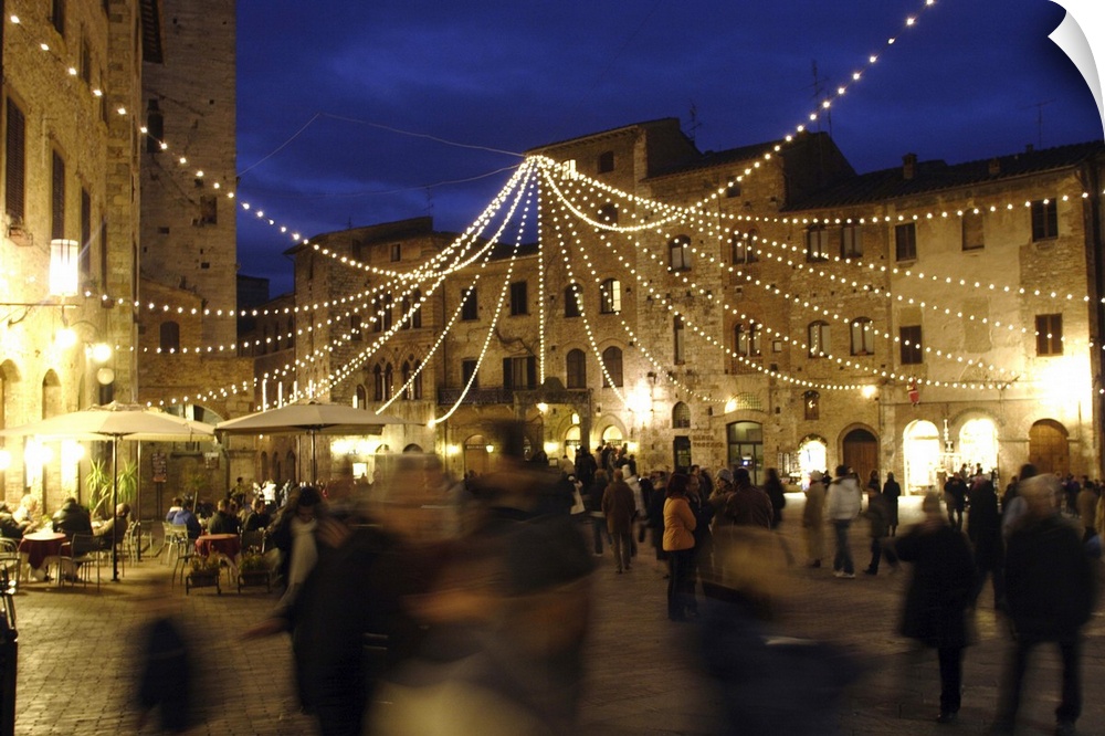 Evening stroll in the central square, under Christmas decorations.

San Gimignano is a small walled medieval hilltop tow...