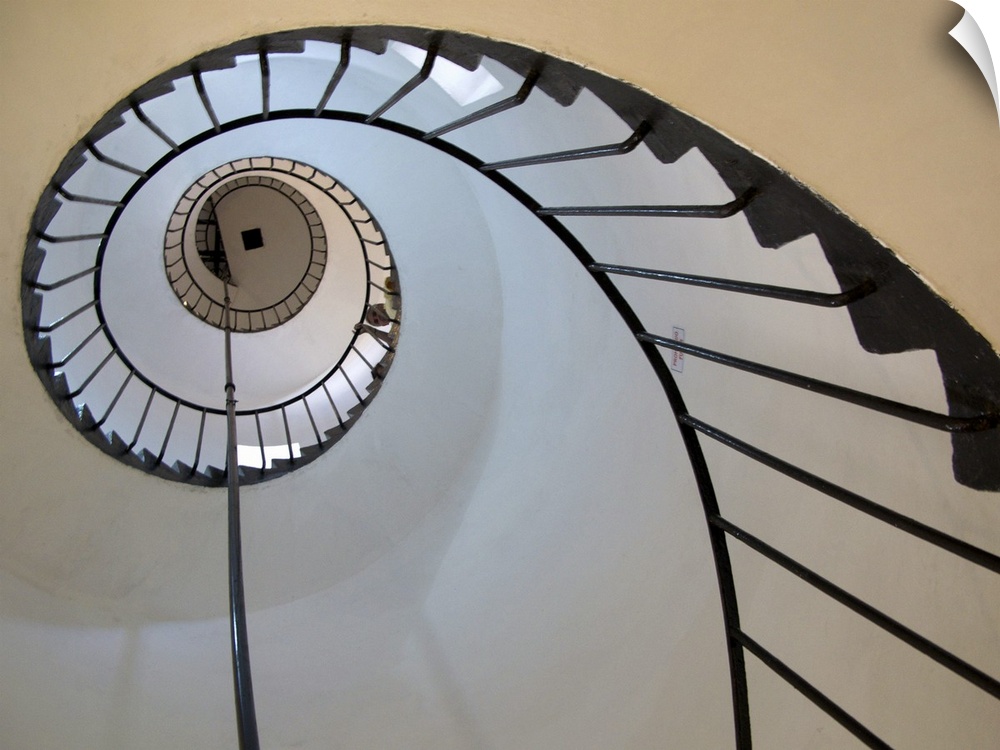 Decorative artwork of a spiral staircase taken from below and looking up.