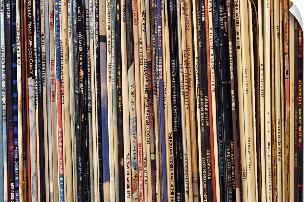 Horizontal, close up photograph of a row of tightly packed records in their sleeves.