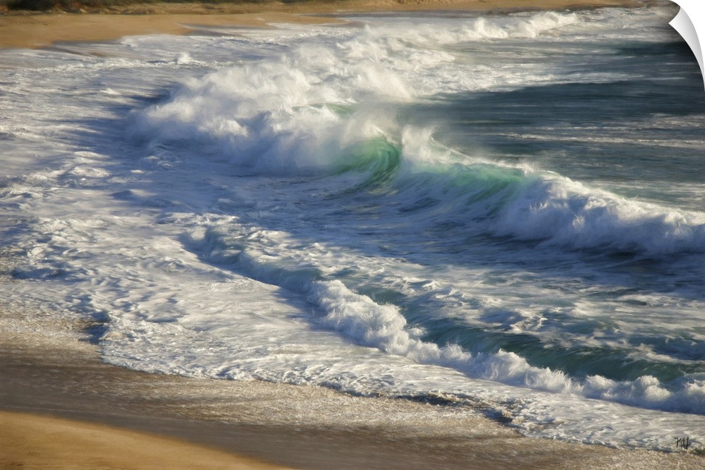 Late afternoon light adds warmth to the crest of this wave in Carmel, California, contrasting with the cool blues and teal...