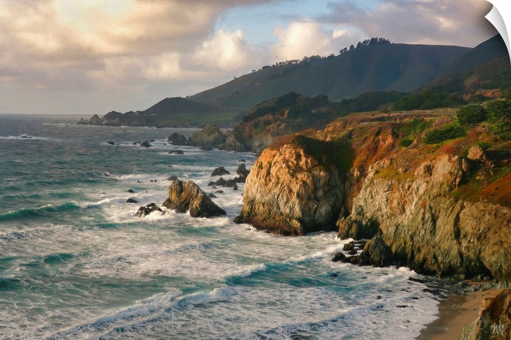 The ocean meets a spectacular rock formation near Rocky Creek Bridge in Big Sur, and the teals and blues of the water cont...