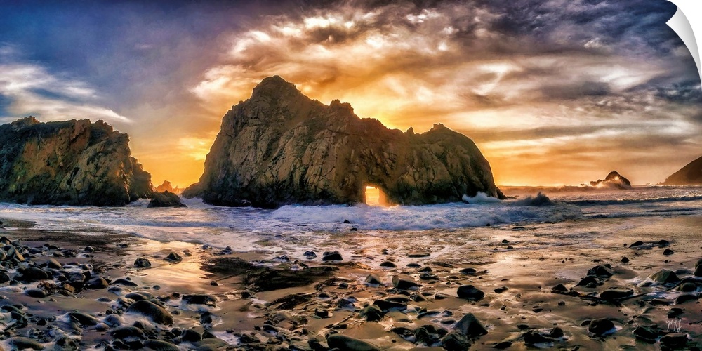 Rays from the setting sun light up the sky and shine a spotlight through the famed "Keyhole" rock formation on Pfeiffer Be...