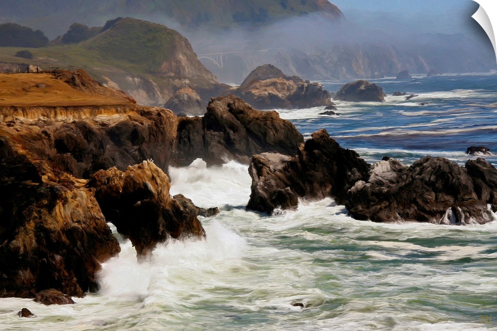 Seagulls perched on a rock formation have a spectacular view of waves crashing on the rugged Big Sur coast. In the distanc...