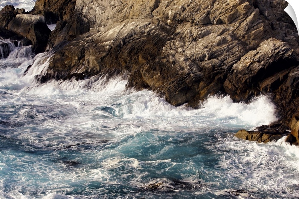 Waves crash into a rock formation at Point Lobos State Park, just south of the Monterey Peninsula and Carmel-by-the-Sea. M...