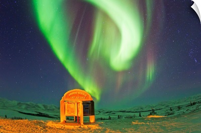 An aurora borealis near the famous Arctic Circle sign