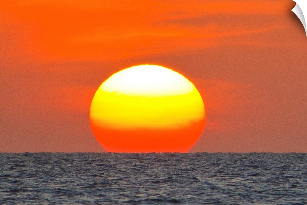 Close up of the sun setting over the Gulf of Mexico.