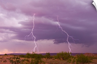 Intense purple lightning bolts strike in the desert of New Mexico