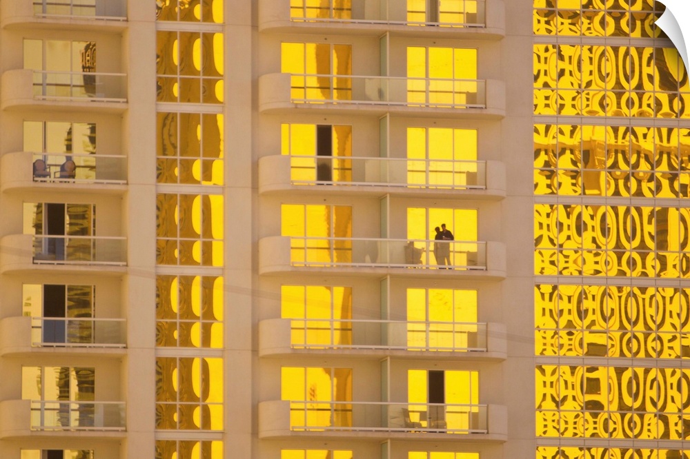 Sunlight reflects bright gold on high rise casino windows.