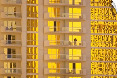 Sunlight reflects bright gold on high rise casino windows