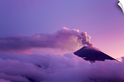 The cloud-shrouded Tungurahua volcano erupting at twilight