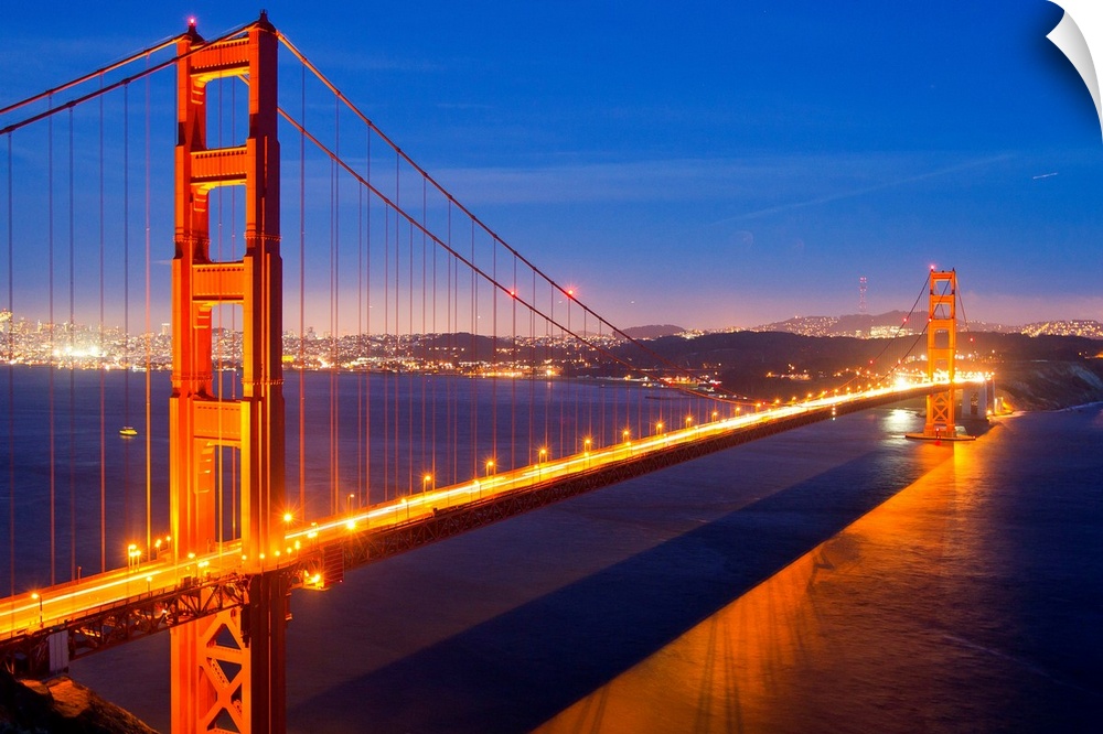 The Golden Gate Bridge illuminated at night.