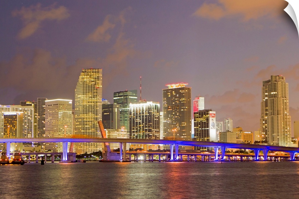 The Miami causeway and skyline at night.