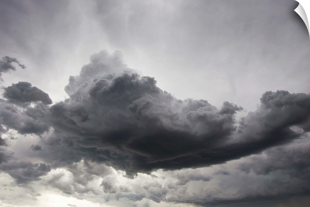 Underneath a supercell thunderstorm with dark and eerie storm clouds.
