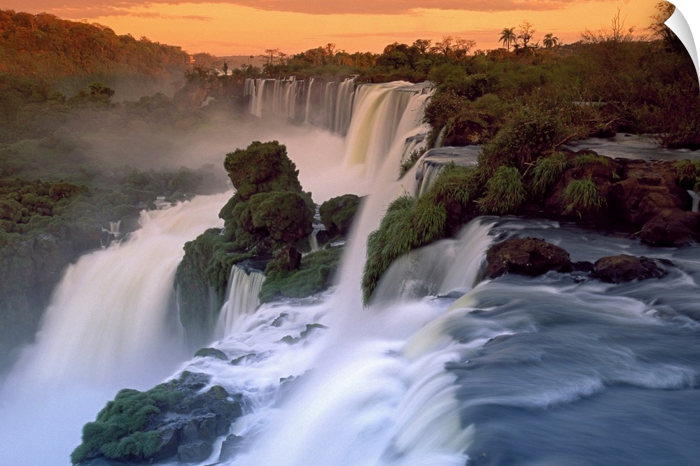 This wall art is a landscape photograph taken from above of an enormous South American waterfall at sunset.